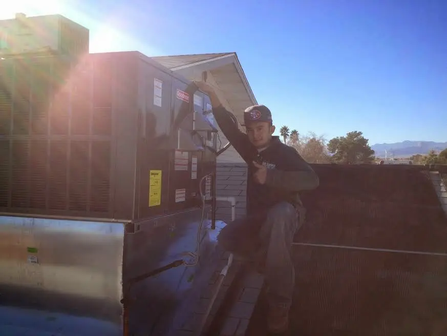 HVAC technician performing HVAC Inspection on a rooftop unit in Brunswick